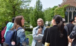 Students standing outside of Saieh hall, laughing